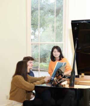 Piano pedagogy students around a piano